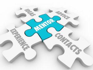 Mentor puzzle piece in blue in the center surrounded by white puzzle pieces with words advice, ideas, experience, contacts