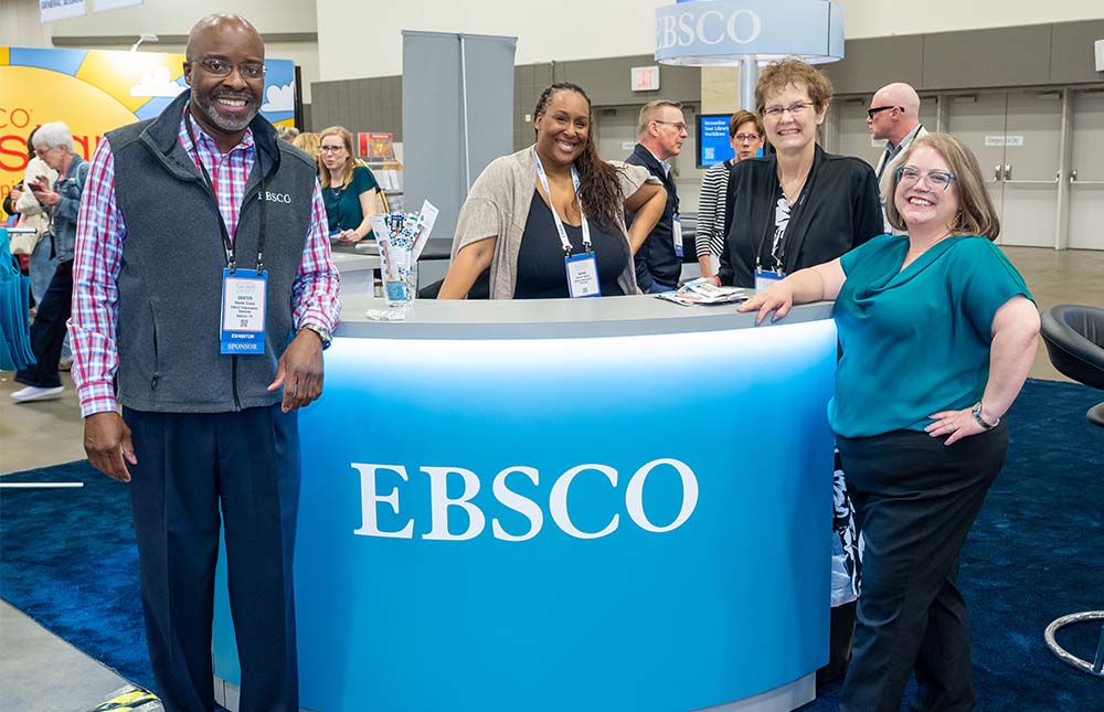 EBSCO staff and TLA President standing at their booth at TLA Annual Conference.