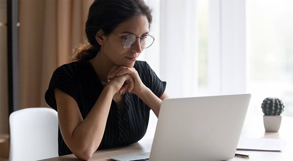 Woman sitting at a desk looking at a computer